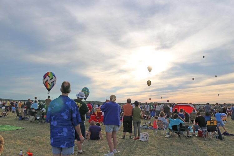 people at dawn watching balloons inflate at one of my favorite hot air balloon festivals