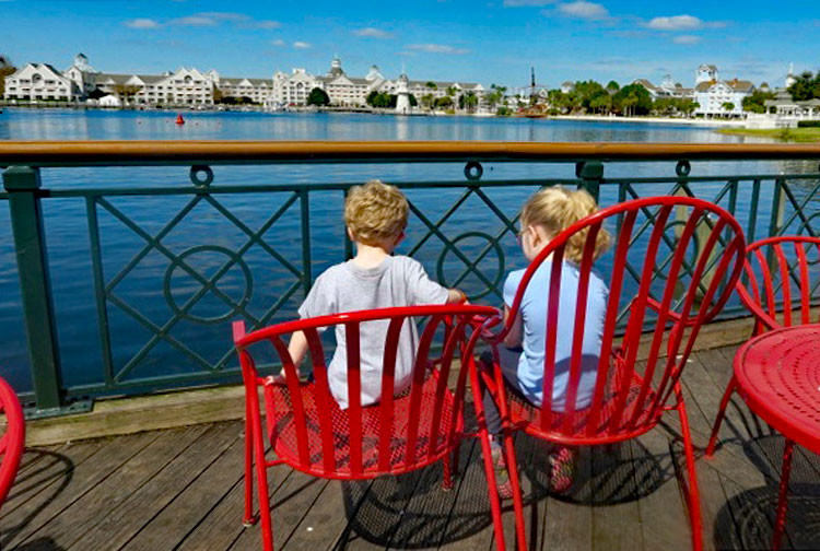 children sit on Disney's Boardwalk, a great place for families to hang out