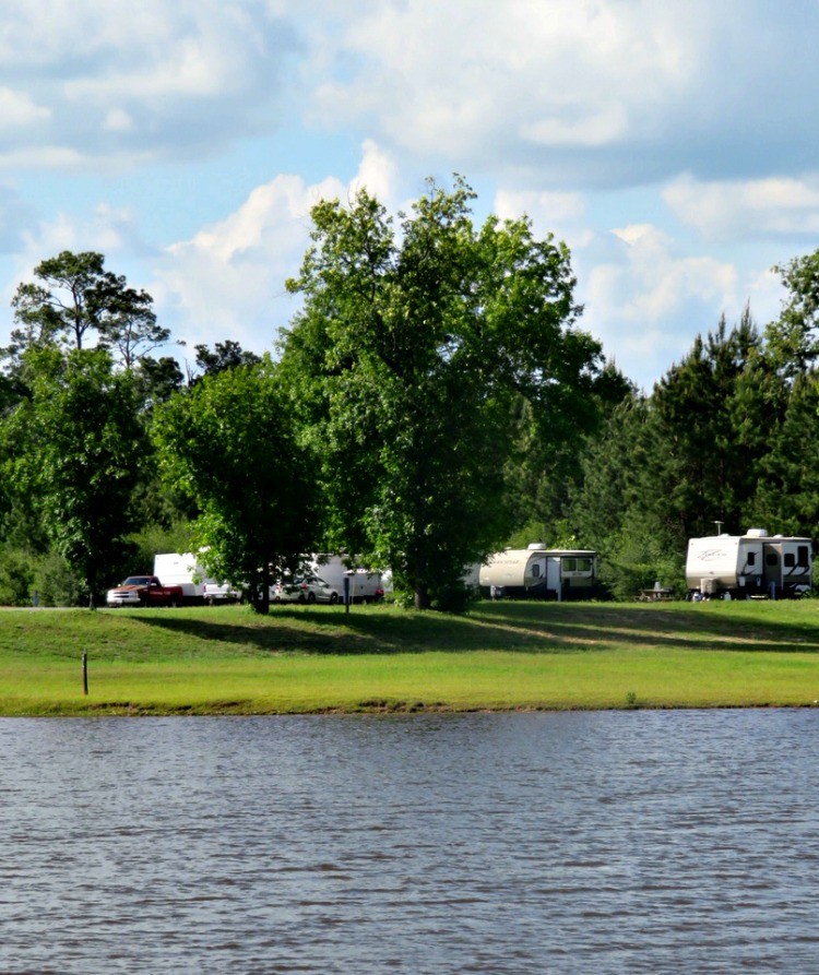 Families own the open road when they go travel trailer camping.