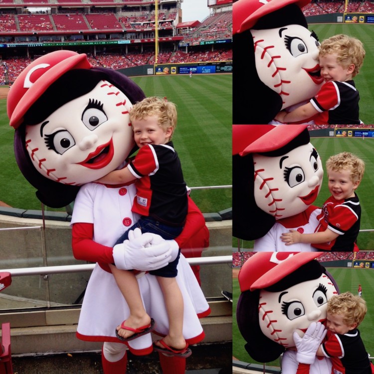 Cincinnati Reds mascot Rosie Red poses with a preschool boy during a Reds baseball game in Ohio