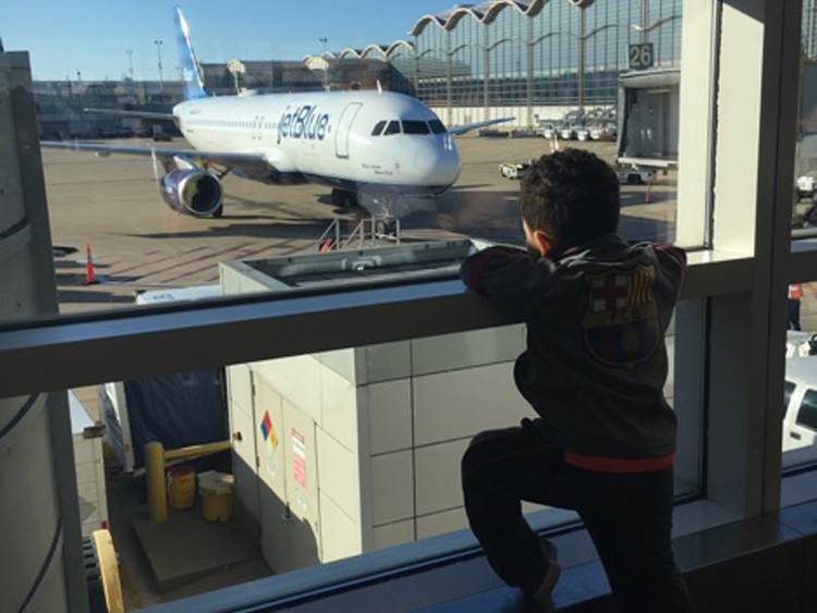 Watching airplanes at the airport can be fun when you travel solo with a toddler!