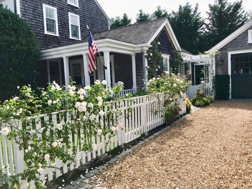 Saltbox cottage with picket fence and roses on Martha's Vineyard, a northeast road trip stop