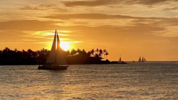 Sailboat in front of sunset in Key West, Florida, a great place to visit in November